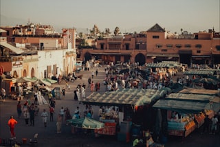 A bustling market square is filled with people.