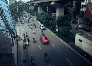 Traffic on a busy city street with overpass.