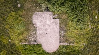 gray concrete tomb on green grass field